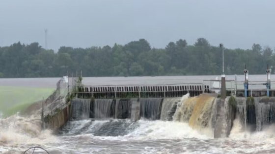 River Surges Over Wisconsin Dam Amid Heavy Rain, Imperiling Small City – MASHAHER