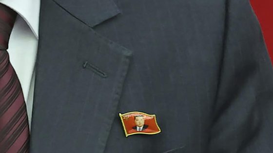 North Koreans are seen wearing Kim Jong Un pins for the first time as his personality cult grows – MASHAHER