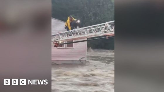 Firefighter crawls across ladder above floods to save woman – MASHAHER