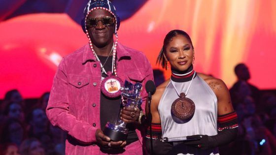 Flavor Flav Gives Jordan Chiles a Bronze Stop Watch Chain at MTV VMAs – MASHAHER